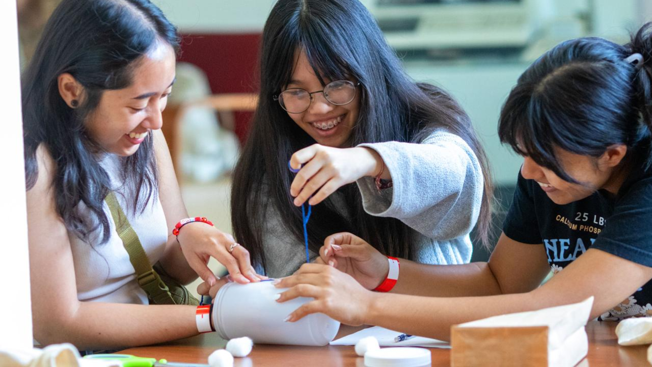 Three Students at UC Davis participate in an engineering workshop exercise.