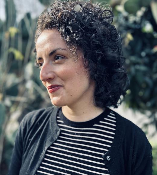 A woman with a striped shirt and sweater