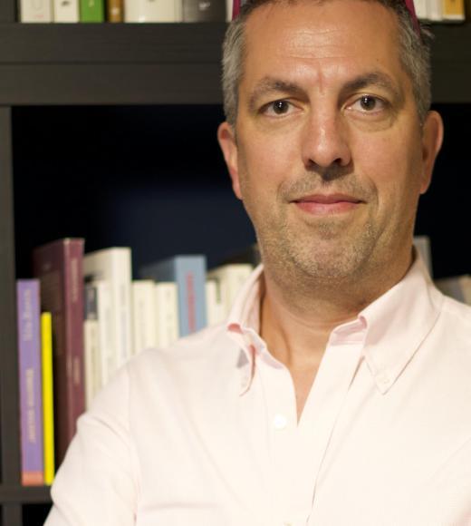 A photo of a man in a light pink shirt.