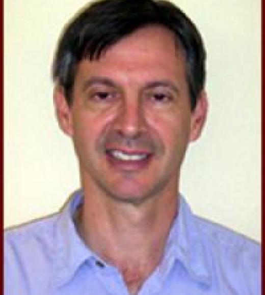 A portrait of a man in a collared shirt