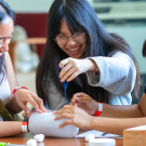 Three Students at UC Davis participate in an engineering workshop exercise.