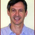 A portrait of a man in a collared shirt